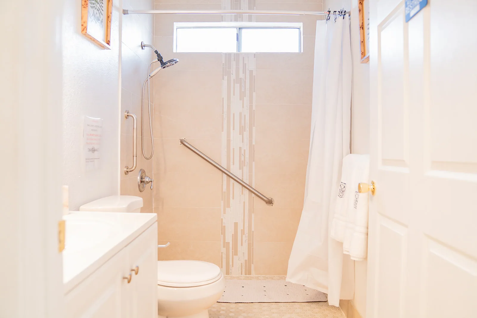 Accessible bathroom with safety grab bars at ACME Group Home.